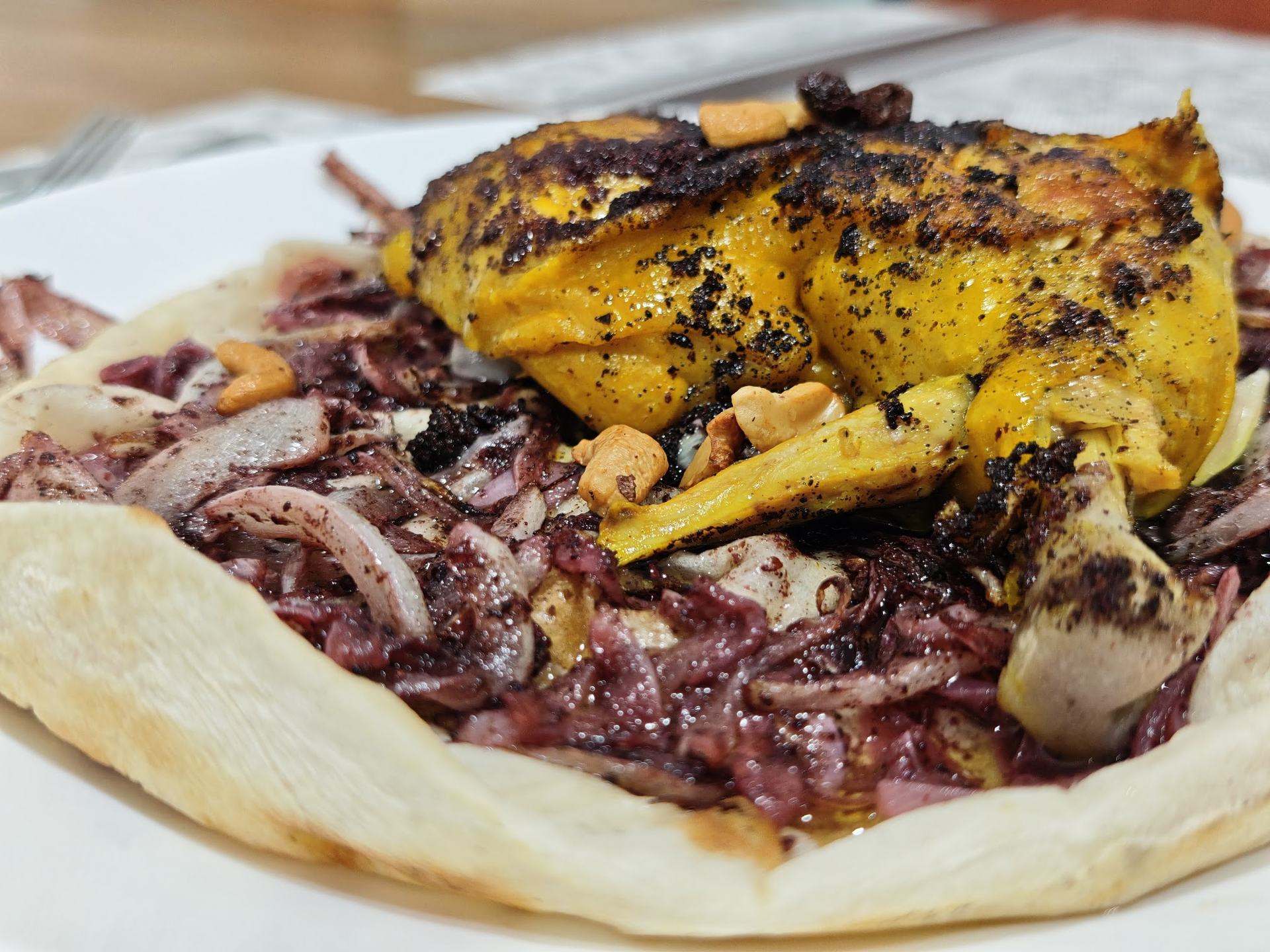 Close-up of traditional Palestinian musakhan — sumac chicken and caramelised onions